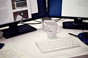 mug, keyboards and computer screens
